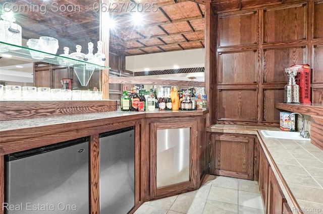 2300 Canyon Ridge Dr, White Lake, MI 48383 - indoor dry bar with fridge and light tile patterned floors