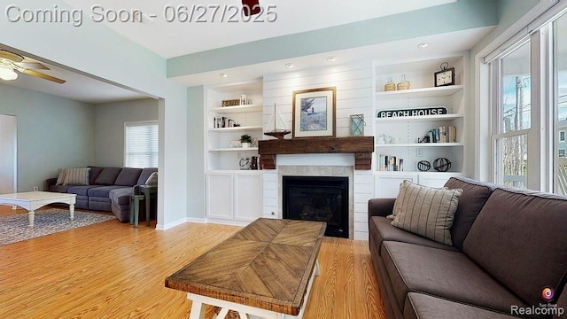 229 Huron St, South Haven, MI 49090 - living room with light wood-style floors, a ceiling fan, built in shelves, a tile fireplace, and recessed lighting