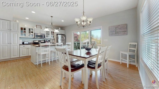229 Huron St, South Haven, MI 49090 - dining space featuring light wood-style flooring, a chandelier, and recessed lighting