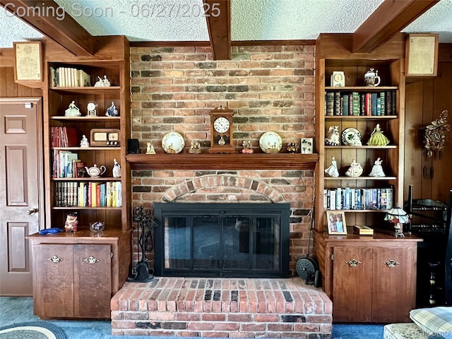 9276 Old Plank Ln, Brighton, MI 48114 - carpeted living area featuring beam ceiling, a brick fireplace, and a textured ceiling