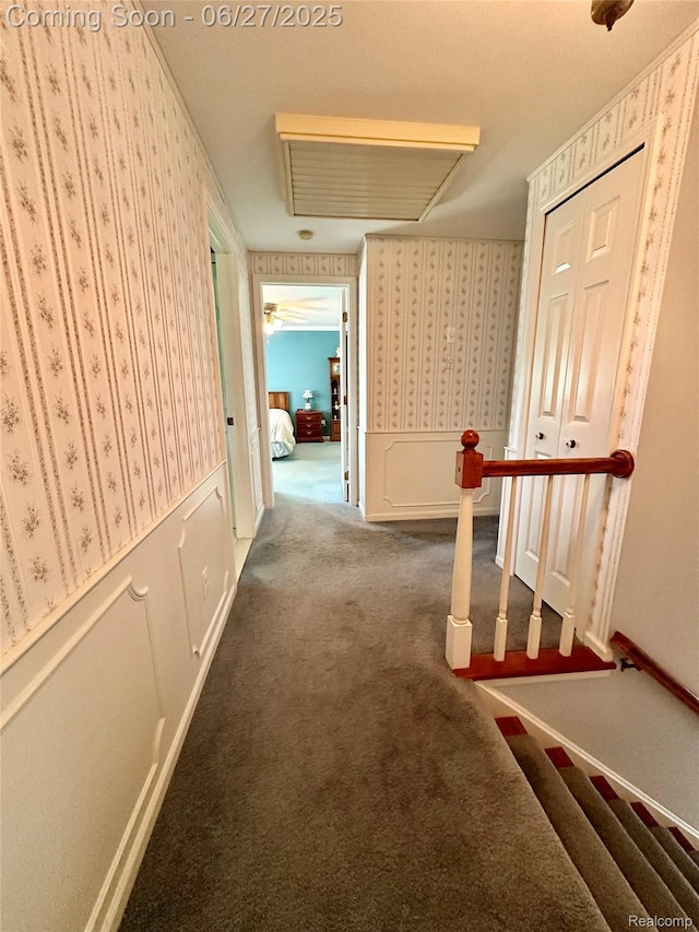 9276 Old Plank Ln, Brighton, MI 48114 - hall featuring wallpapered walls, carpet floors, wainscoting, and an upstairs landing