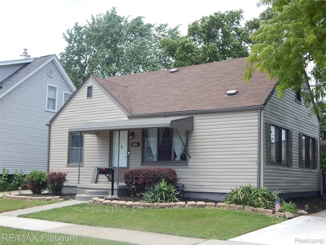 22133 Rosedale St, Saint Clair Shores, MI 48080 - view of front of house featuring covered porch, a shingled roof, and a front lawn