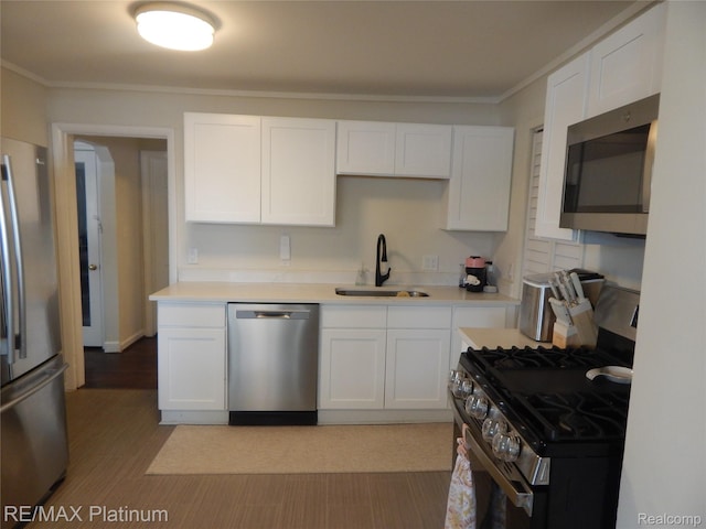 22133 Rosedale St, Saint Clair Shores, MI 48080 - kitchen with stainless steel appliances, white cabinets, light countertops, ornamental molding, and wood finished floors