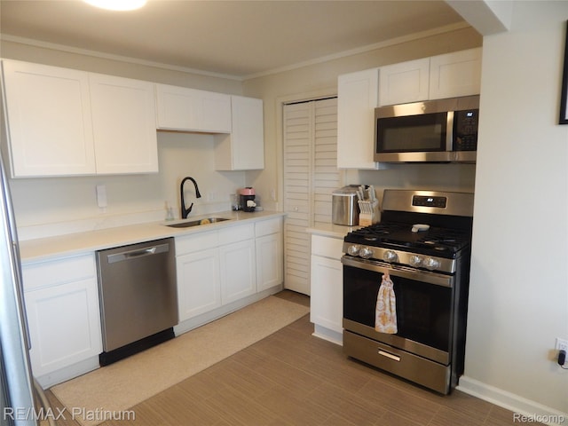 22133 Rosedale St, Saint Clair Shores, MI 48080 - kitchen featuring stainless steel appliances, white cabinetry, light countertops, and crown molding