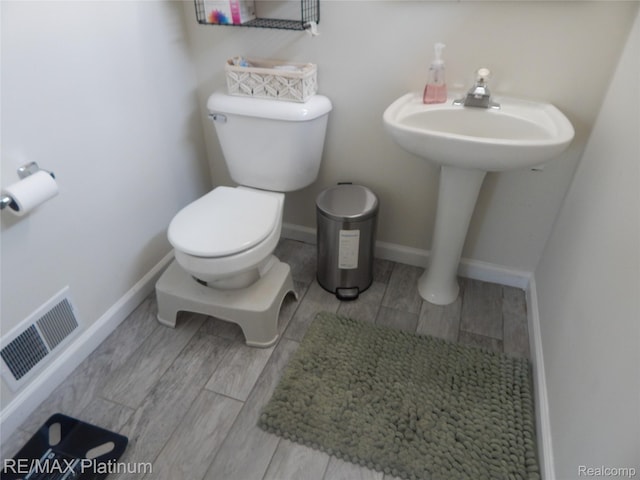22133 Rosedale St, Saint Clair Shores, MI 48080 - bathroom with toilet and wood finished floors