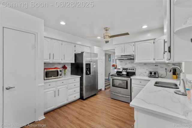 21415 Lathrup St, Southfield, MI 48075 - kitchen featuring stainless steel appliances, under cabinet range hood, white cabinetry, a ceiling fan, and recessed lighting