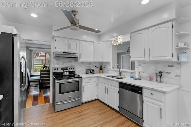 21415 Lathrup St, Southfield, MI 48075 - kitchen with stainless steel appliances, under cabinet range hood, a ceiling fan, white cabinetry, and light wood-style floors