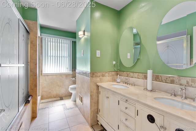 21415 Lathrup St, Southfield, MI 48075 - full bathroom with double vanity, tile walls, tile patterned floors, and a wainscoted wall