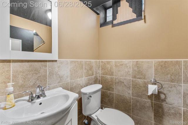 21415 Lathrup St, Southfield, MI 48075 - half bath featuring a wainscoted wall, vanity, and tile walls