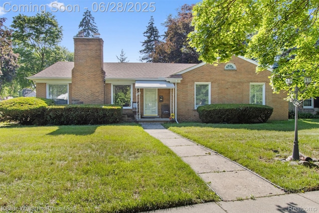 21415 Lathrup St, Southfield, MI 48075 - view of front of house with brick siding, a front yard, a chimney, and roof with shingles
