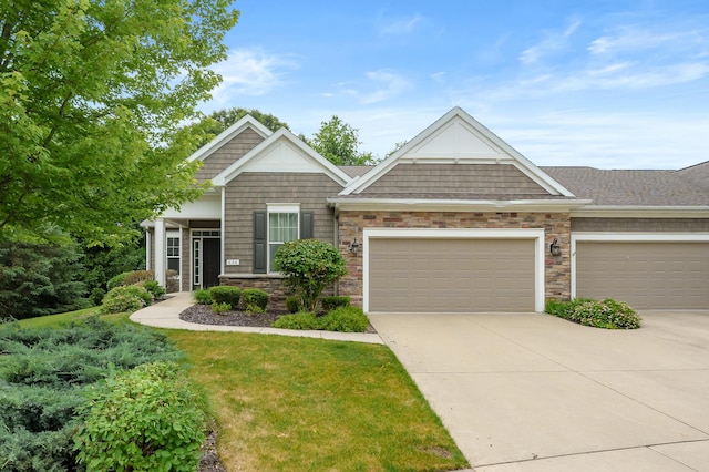 636 Wynding Oaks, Kalamazoo, MI 49006 - craftsman house with driveway, an attached garage, stone siding, and a front lawn