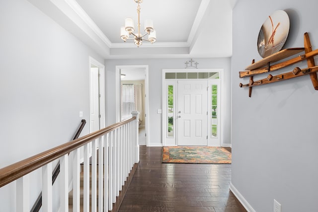 636 Wynding Oaks, Kalamazoo, MI 49006 - foyer featuring a chandelier, dark wood-type flooring, a raised ceiling, and crown molding