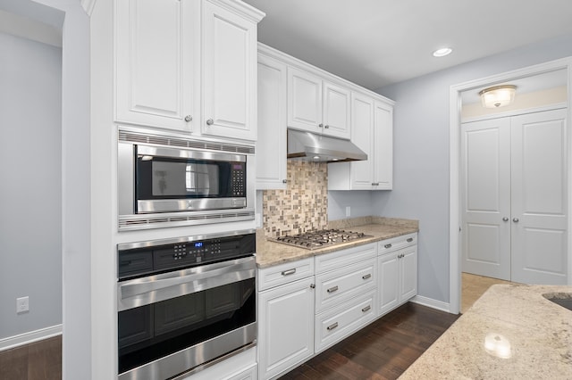 636 Wynding Oaks, Kalamazoo, MI 49006 - kitchen with appliances with stainless steel finishes, under cabinet range hood, light stone countertops, white cabinetry, and recessed lighting