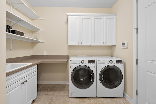 636 Wynding Oaks, Kalamazoo, MI 49006 - laundry area with cabinet space, separate washer and dryer, and light tile patterned flooring
