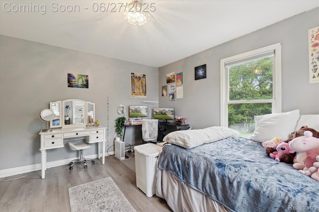 1453 Maplewood Dr, Saline, MI 48176 - bedroom featuring wood finished floors, a chandelier, and a desk
