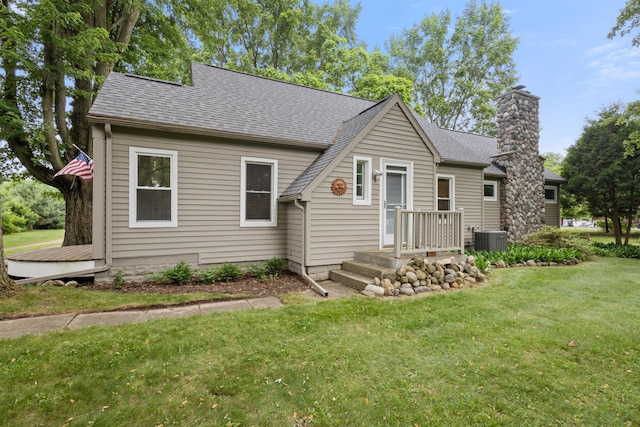 9708 Oakland Dr, Portage, MI 49024 - view of front facade featuring a front yard, roof with shingles, and a chimney