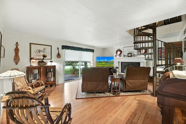8454 Stickles Rd, Three Oaks, MI 49128 - living area featuring wood finished floors, a fireplace, and stairs
