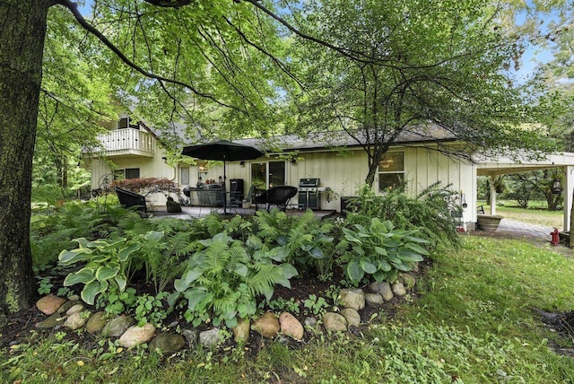 8454 Stickles Rd, Three Oaks, MI 49128 - rear view of house featuring board and batten siding, a patio area, and a balcony