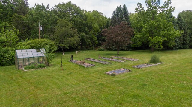 8454 Stickles Rd, Three Oaks, MI 49128 - view of green lawn with an exterior structure, a vegetable garden, and an outdoor structure