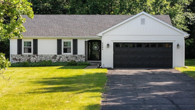 3395 Simsbury Dr, Pinckney, MI 48169 - view of front of house with a shingled roof, driveway, stone siding, and an attached garage