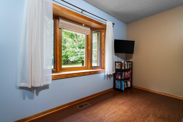 3395 Simsbury Dr, Pinckney, MI 48169 - unfurnished room featuring wood finished floors and a textured ceiling
