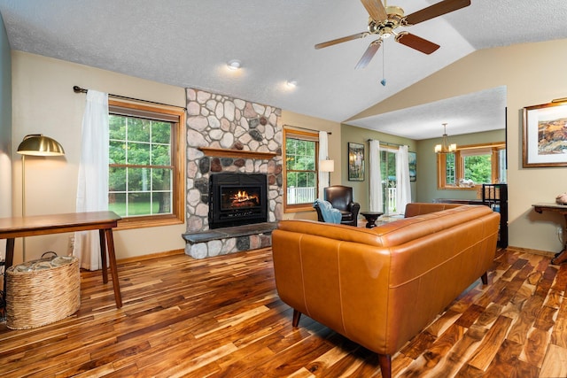 3395 Simsbury Dr, Pinckney, MI 48169 - living room featuring wood finished floors, lofted ceiling, a fireplace, a textured ceiling, and ceiling fan