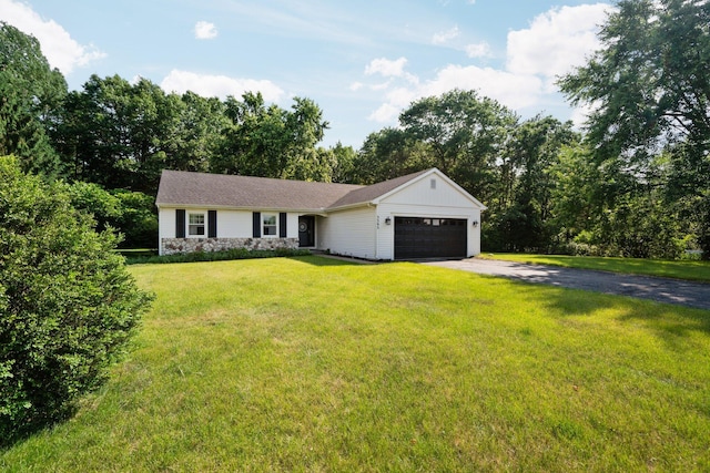 3395 Simsbury Dr, Pinckney, MI 48169 - single story home featuring an attached garage, asphalt driveway, a front lawn, and stone siding