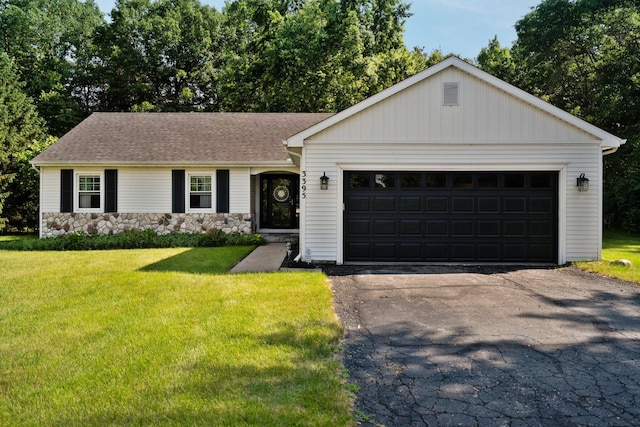 3395 Simsbury Dr, Pinckney, MI 48169 - ranch-style house featuring a front lawn, stone siding, asphalt driveway, and a garage