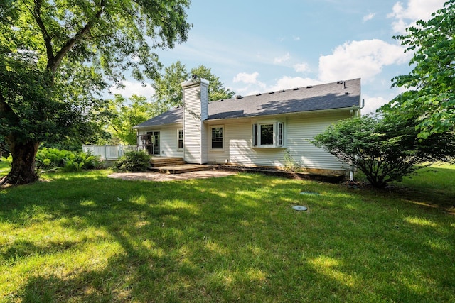 3395 Simsbury Dr, Pinckney, MI 48169 - back of property featuring a lawn and a chimney