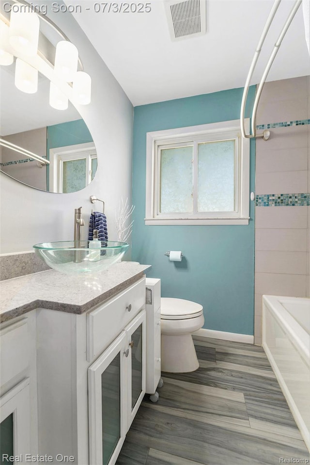 29038 Spoon Ave, Madison Heights, MI 48071 - bathroom with vanity, plenty of natural light, wood finished floors, and shower / bathtub combination