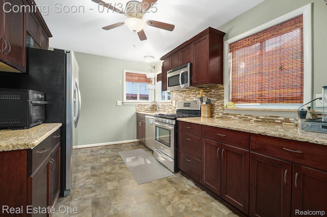 29038 Spoon Ave, Madison Heights, MI 48071 - kitchen featuring stainless steel appliances, a ceiling fan, decorative backsplash, light stone countertops, and stone finish floors
