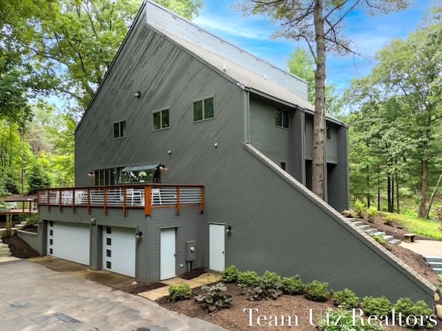 410 Greentree Ln NE, Ada, MI 49301 - back of house with a garage and concrete driveway