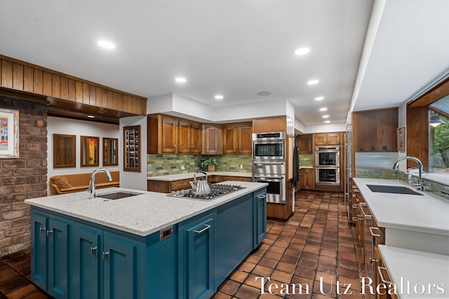 410 Greentree Ln NE, Ada, MI 49301 - kitchen with an island with sink, tasteful backsplash, stainless steel appliances, a warming drawer, and recessed lighting