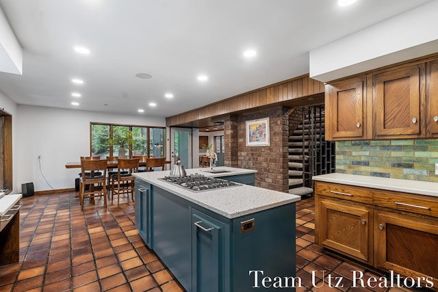 410 Greentree Ln NE, Ada, MI 49301 - kitchen featuring stainless steel gas stovetop, tasteful backsplash, light countertops, a kitchen island, and recessed lighting