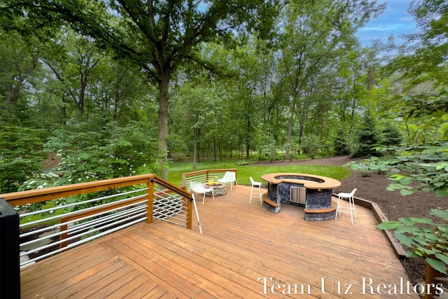 410 Greentree Ln NE, Ada, MI 49301 - wooden deck with an outdoor fire pit