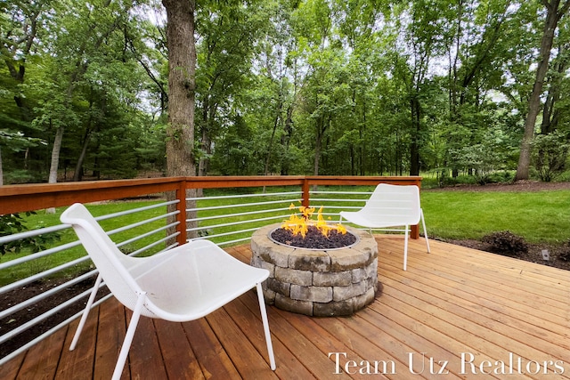410 Greentree Ln NE, Ada, MI 49301 - wooden deck featuring a fire pit and a lawn