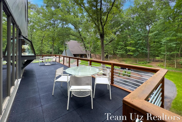 410 Greentree Ln NE, Ada, MI 49301 - balcony featuring outdoor dining space