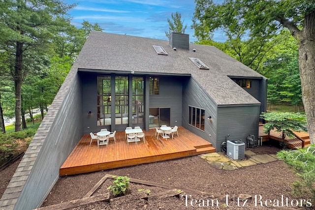 410 Greentree Ln NE, Ada, MI 49301 - rear view of property featuring roof with shingles and a deck
