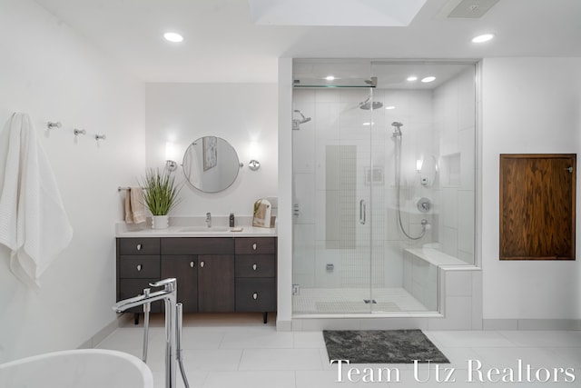 410 Greentree Ln NE, Ada, MI 49301 - bathroom with vanity, a shower stall, tile patterned floors, a freestanding tub, and recessed lighting