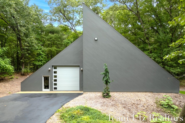 410 Greentree Ln NE, Ada, MI 49301 - view of home's exterior with a garage