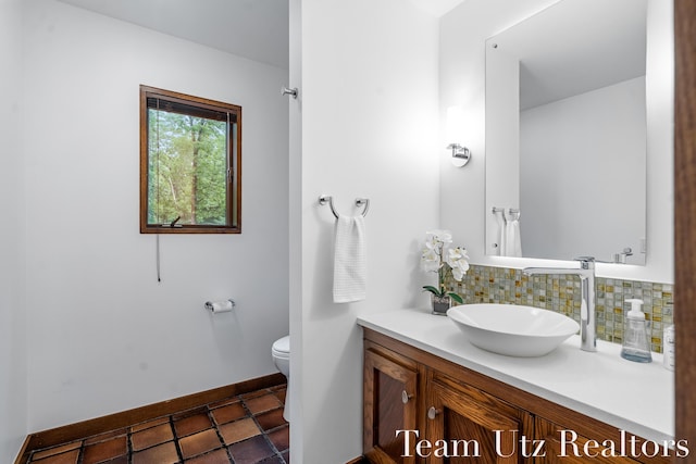 410 Greentree Ln NE, Ada, MI 49301 - bathroom featuring vanity, decorative backsplash, and tile patterned flooring