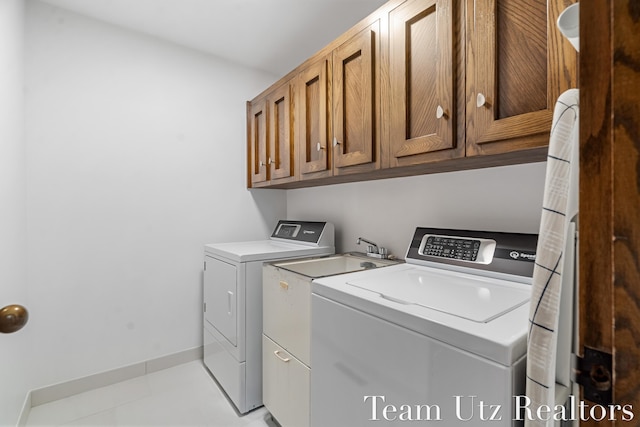 410 Greentree Ln NE, Ada, MI 49301 - washroom with washing machine and dryer and cabinet space