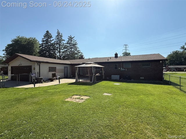 53240 Odilon Ave, Shelby Twp, MI 48316 - back of property featuring a gazebo, a patio, a garage, a gate, and brick siding