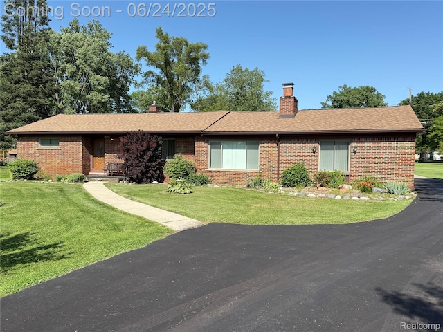 53240 Odilon Ave, Shelby Twp, MI 48316 - view of front of property featuring brick siding, a chimney, and a front lawn