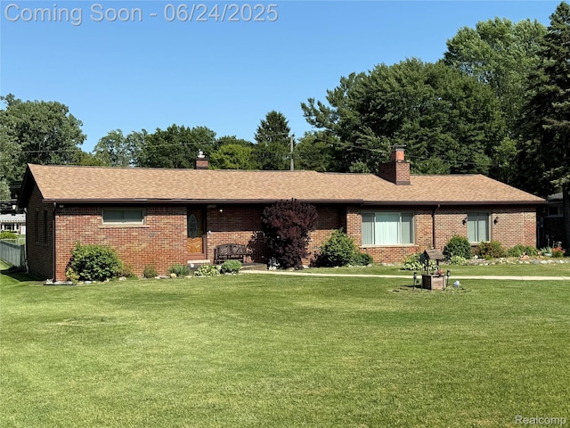 53240 Odilon Ave, Shelby Twp, MI 48316 - ranch-style home with a chimney, a front lawn, and brick siding