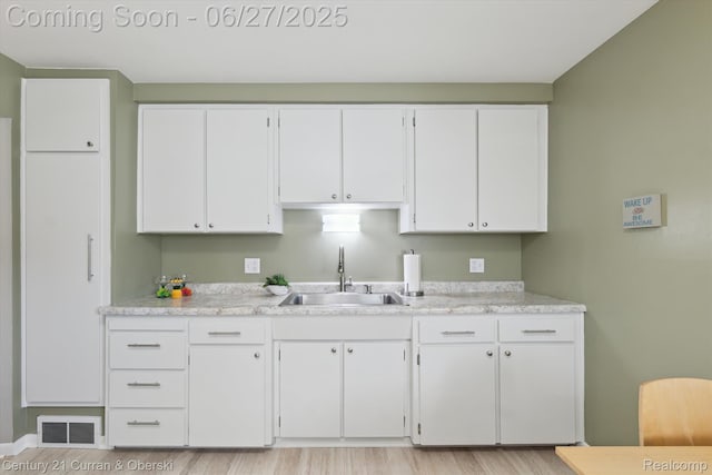 11769 Eileen, Redford, MI 48239 - kitchen with white cabinetry, light countertops, and light wood finished floors