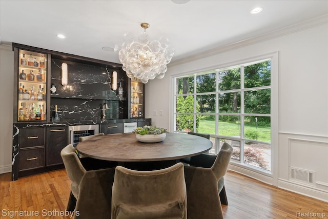 4438 Stony River Dr, Bloomfield Hills, MI 48301 - dining room featuring crown molding, a chandelier, light wood-style floors, bar area, and recessed lighting