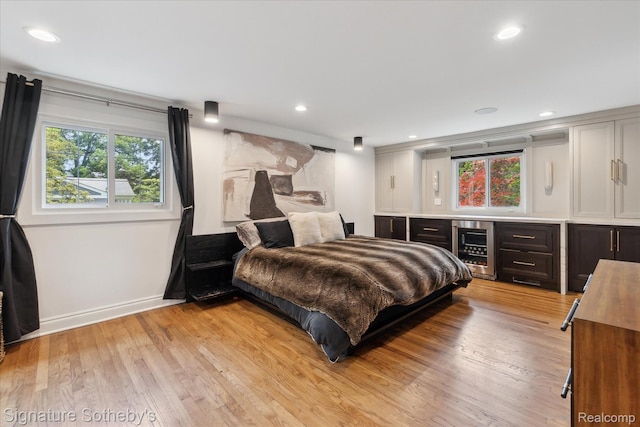 4438 Stony River Dr, Bloomfield Hills, MI 48301 - bedroom featuring beverage cooler, a bar, light wood-style flooring, and recessed lighting