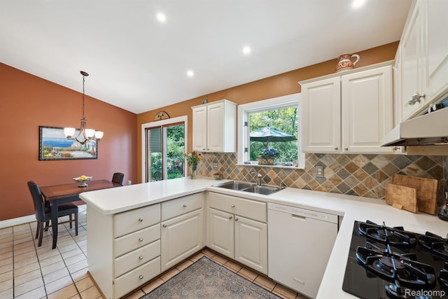 2650 Binbrooke Dr, Troy, MI 48084 - kitchen featuring dishwasher, vaulted ceiling, backsplash, a peninsula, and light countertops