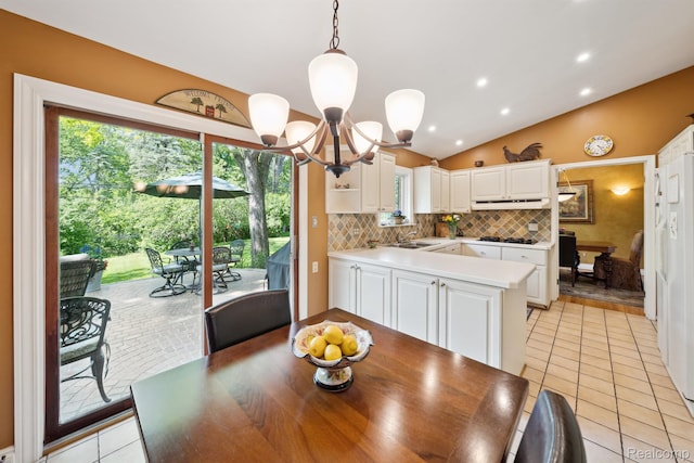 2650 Binbrooke Dr, Troy, MI 48084 - dining room with vaulted ceiling, light tile patterned flooring, and a chandelier